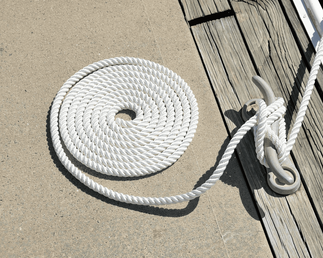 Twisted nylon rope in white color used as a mooring rope