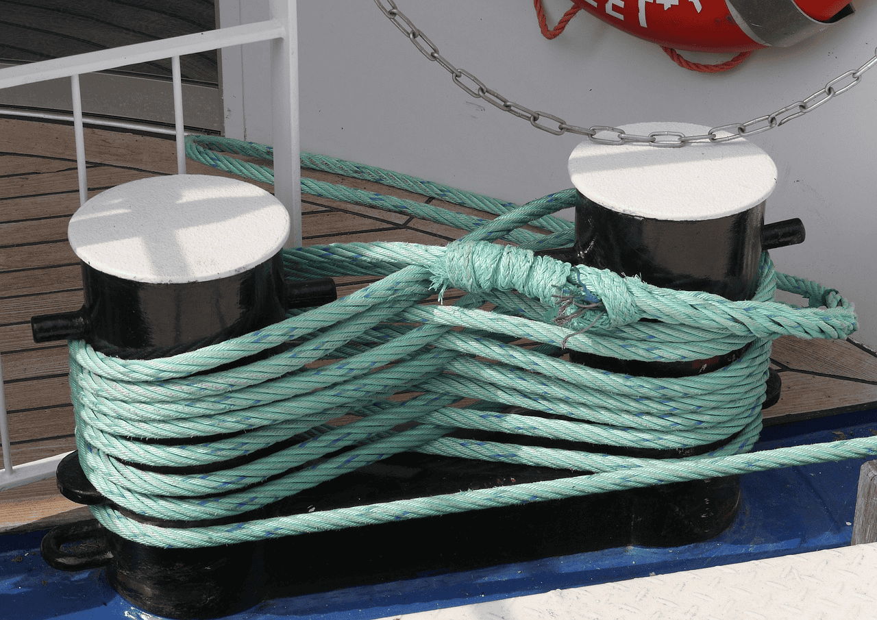 Green Nylon Rope tied to a bollard ship
