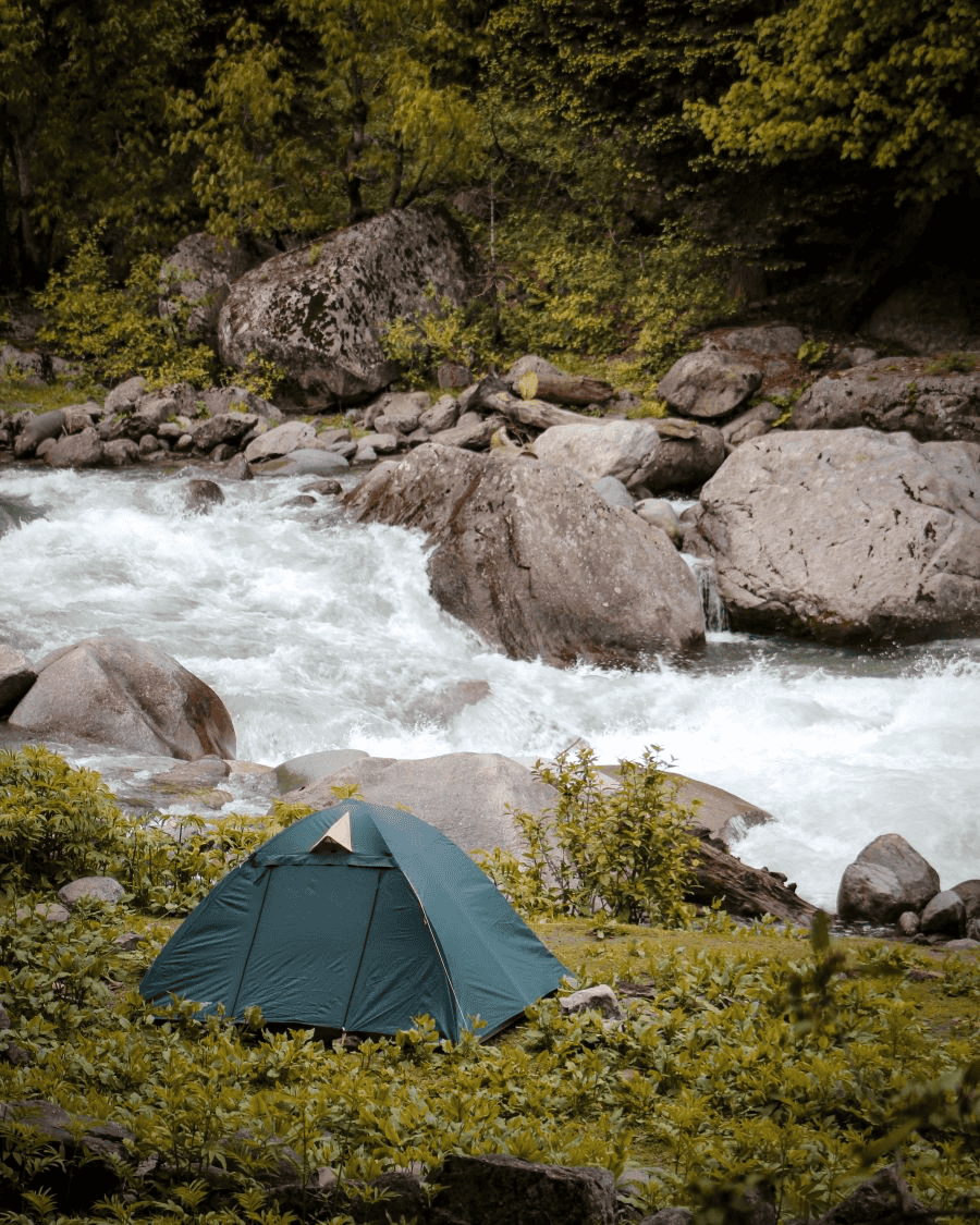 Survival card manufacturers: tent near cascading river water flowing over