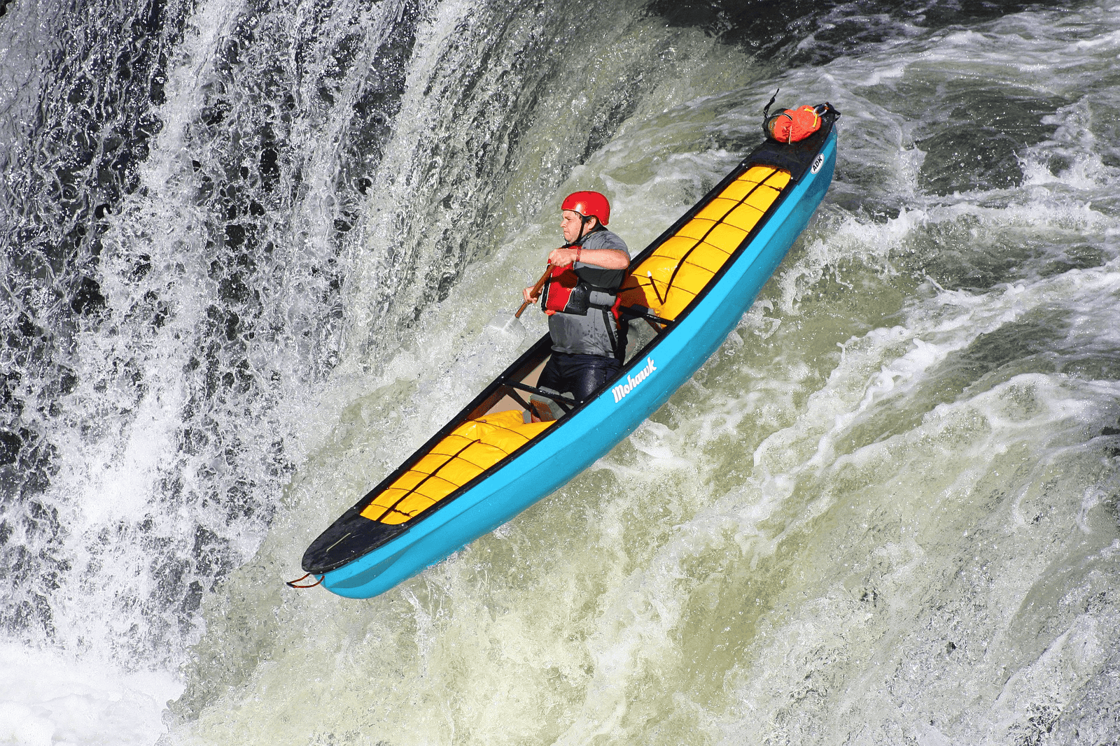 man kayaking with his bag from a dry bag manufacturing firm