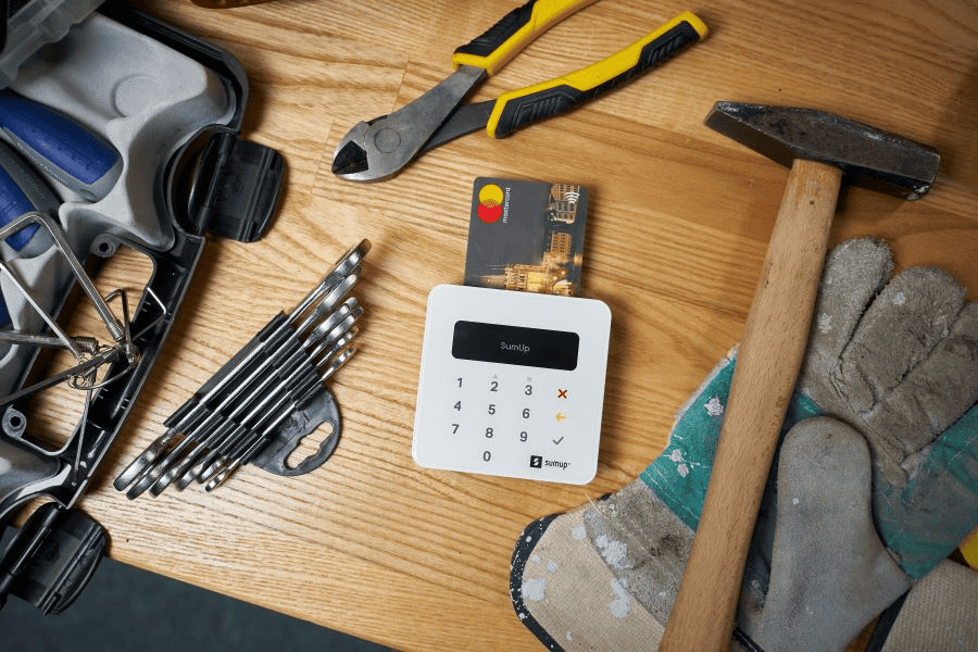 Survival card suppliers: plastic card in modern cash register and construction hand tools