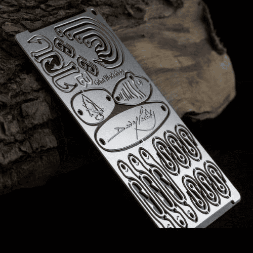 Top 10 Survival Card Suppliers in the UK: A Guide to Outdoor Survival Cards and Where to Buy Them in Bulk 9 Survival card suppliers: Grim Workshop Dave Caterbury Signature Survival Card against a log.