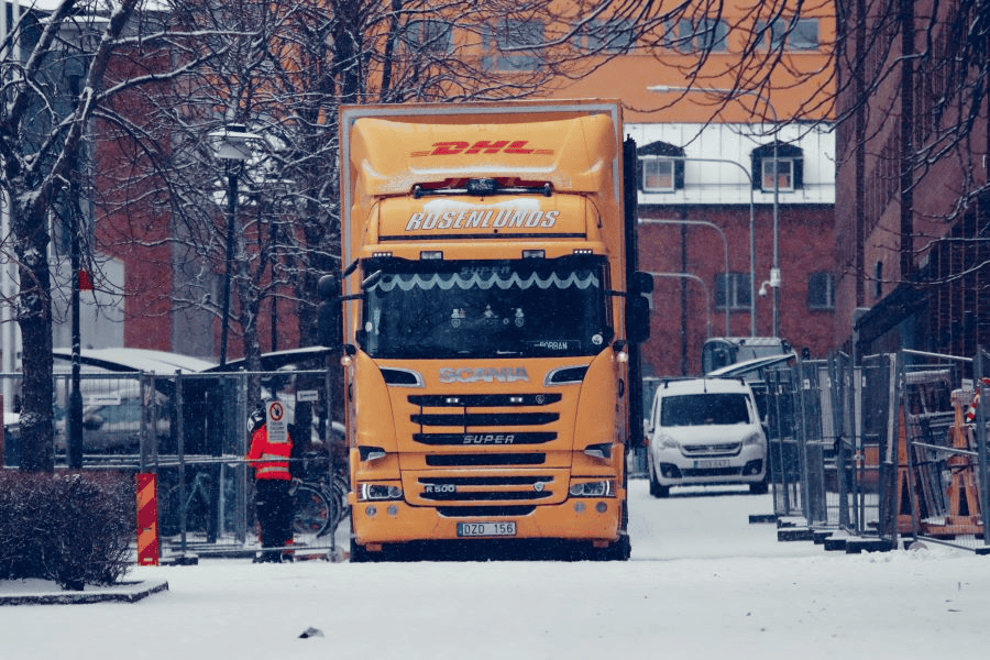 How to Import Paracord from China to Switzerland (Plus Paracord Manufacturer Options for Your Business) 2 Paracord factory: DHL yellow truck on city street in winter.