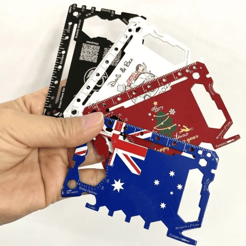 Survival card manufacturers: hand holding survival tool cards with different colors and designs.