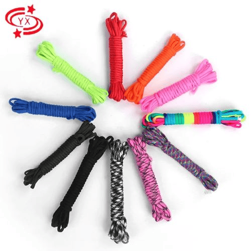 Paracord manufacturing: paracord in multiple colors on white surface.