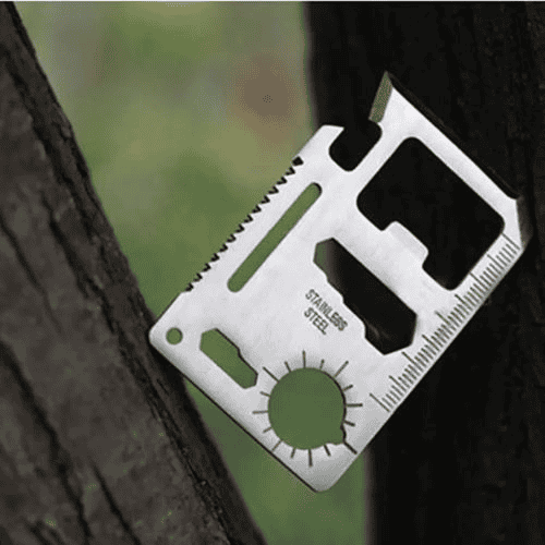Survival card manufacturers: survival card placed between a tree's trunks.