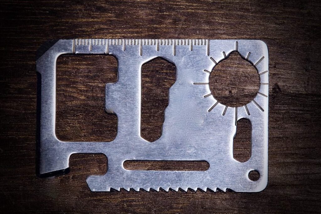 Survival card suppliers: stainless steel survival card on a wooden surface.