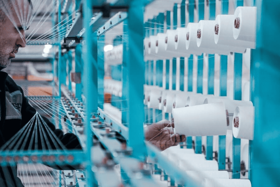 Can You Make Money Selling Paracord from a Reputable Paracord Manufacturer? 6 Paracord wholesale: man in black jacket standing beside blue metal machine.