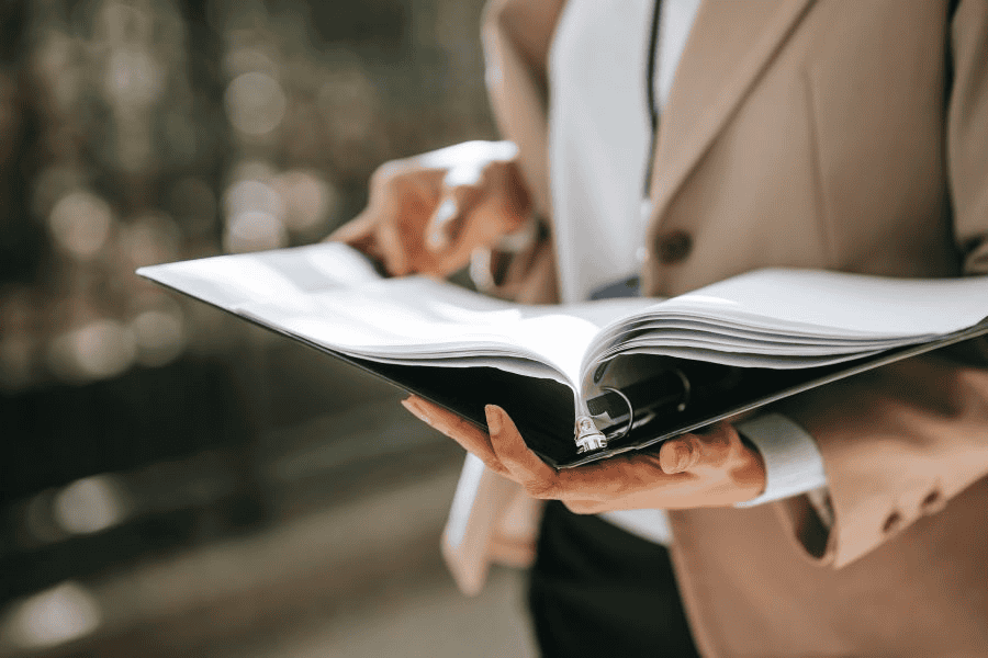 Paracord manufacturing: businesswoman holding papers in folder.