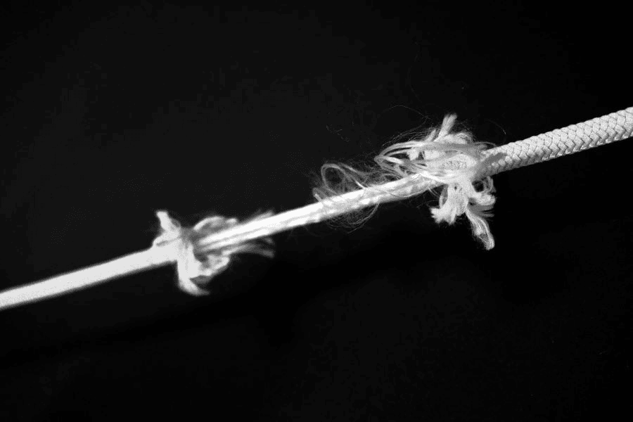 Is There a Better Rope Than Paracord? Exploring Alternatives and Paracord Manufacturer 5 Paracord manufacturing: frayed white rope on a black background.