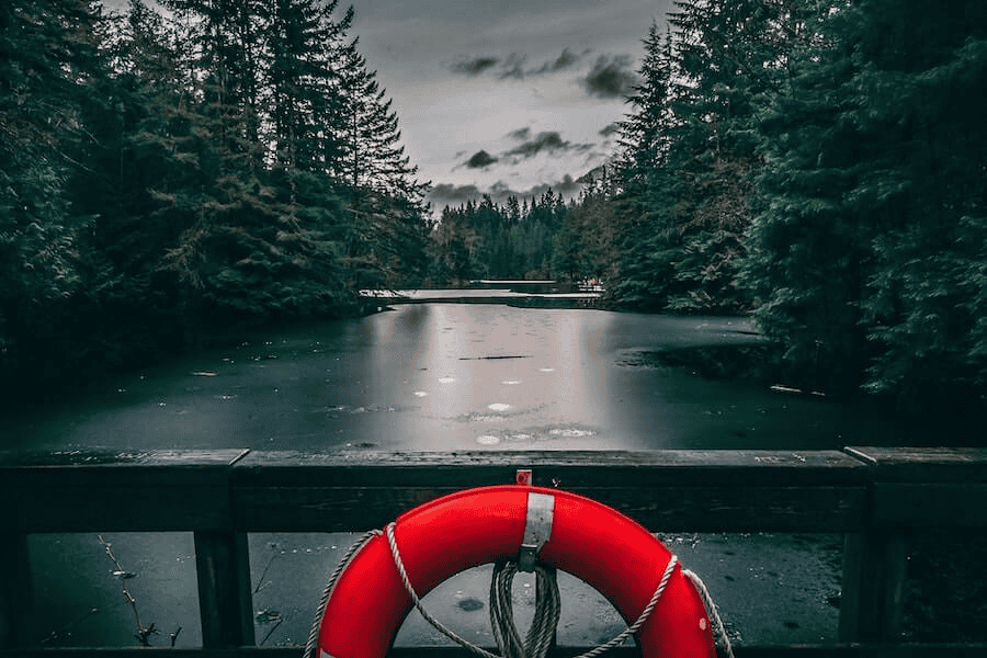Paracord factory: red and white inflatable ring on water.