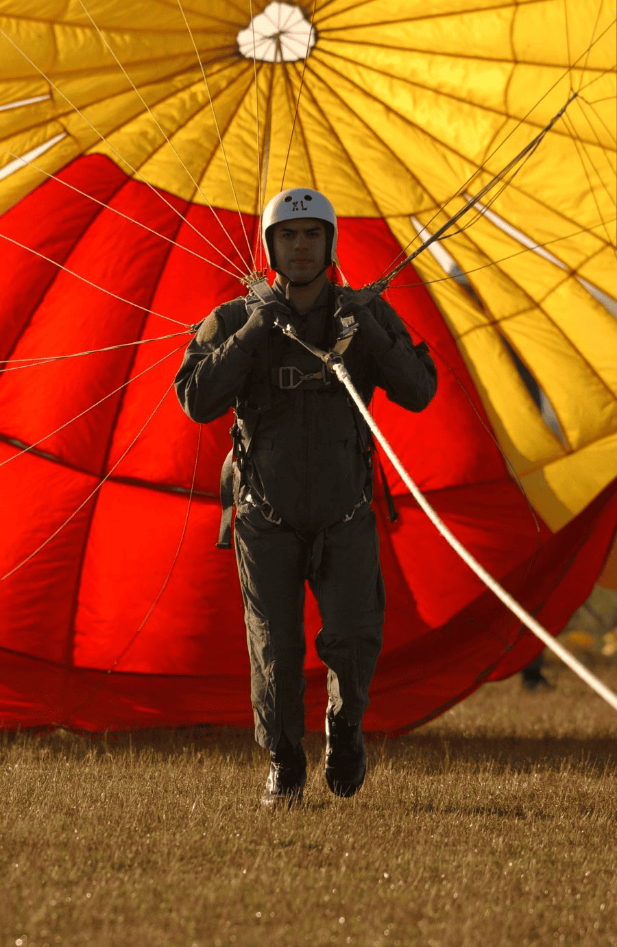 Paracord manufacturing: man wearing gray overall suit and parachute.