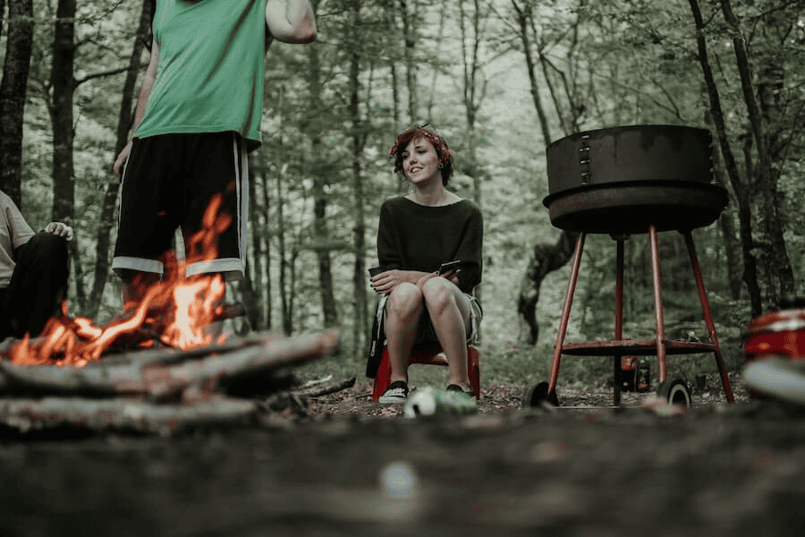 Paracord factory: man and woman gathering around a camp fire.