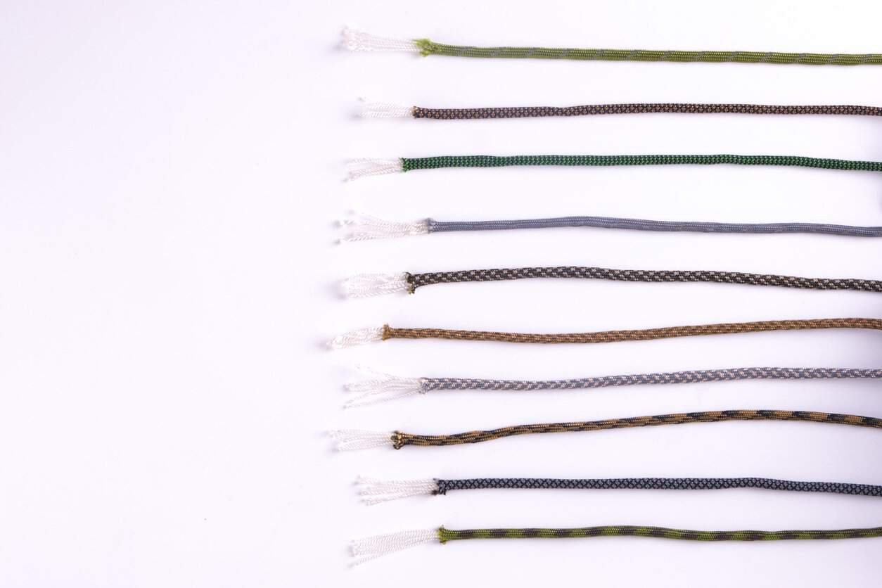 Paracord wholesale with exposed strands on white background.