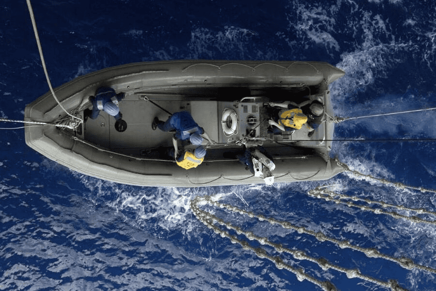 Paracord manufacturing: a gray water rescue boat and knotted ropes.