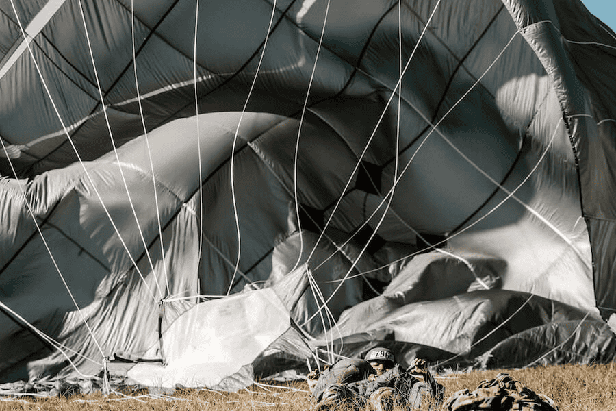 Paracord wholesale: A paratrooper landing on grass.