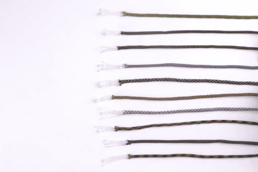 Paracord wholesale: Paracord in different colors and weave patterns on a white surface.