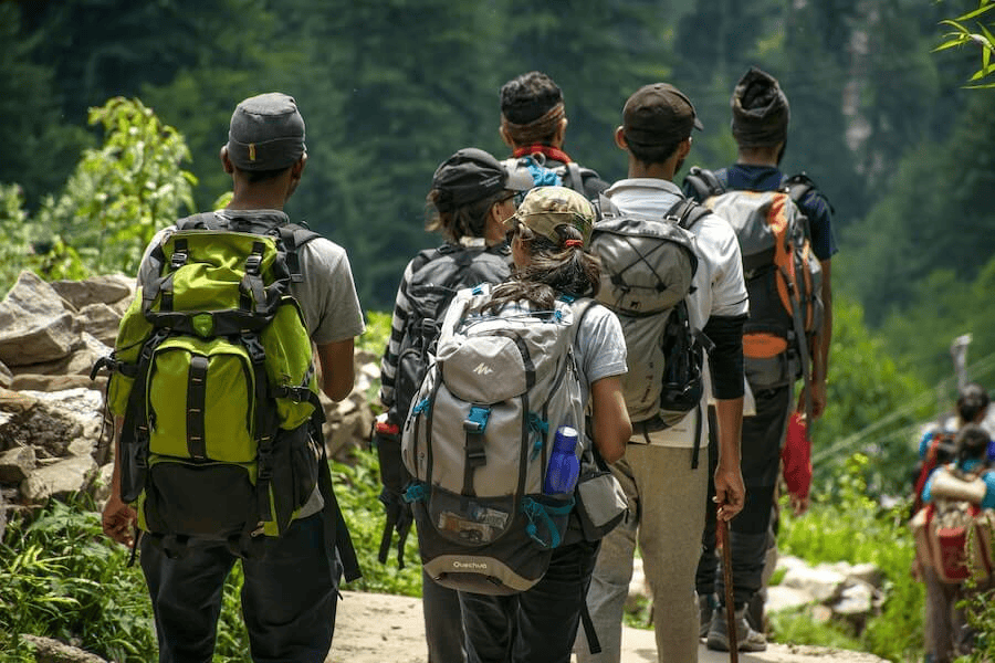 Paracord manufacturing: People walking on a road near trees at daytime.