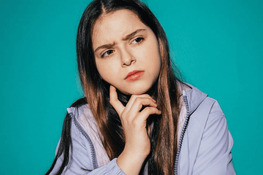 Paracord factory: Girl wearing a purple jacket, thinking.